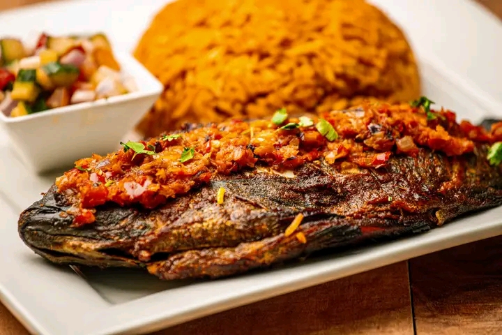 Grilled fish with jollof rice and side salad