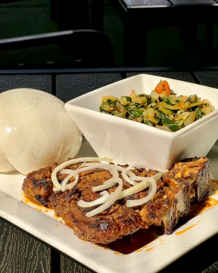 Grilled ribs with fufu and vegetable side